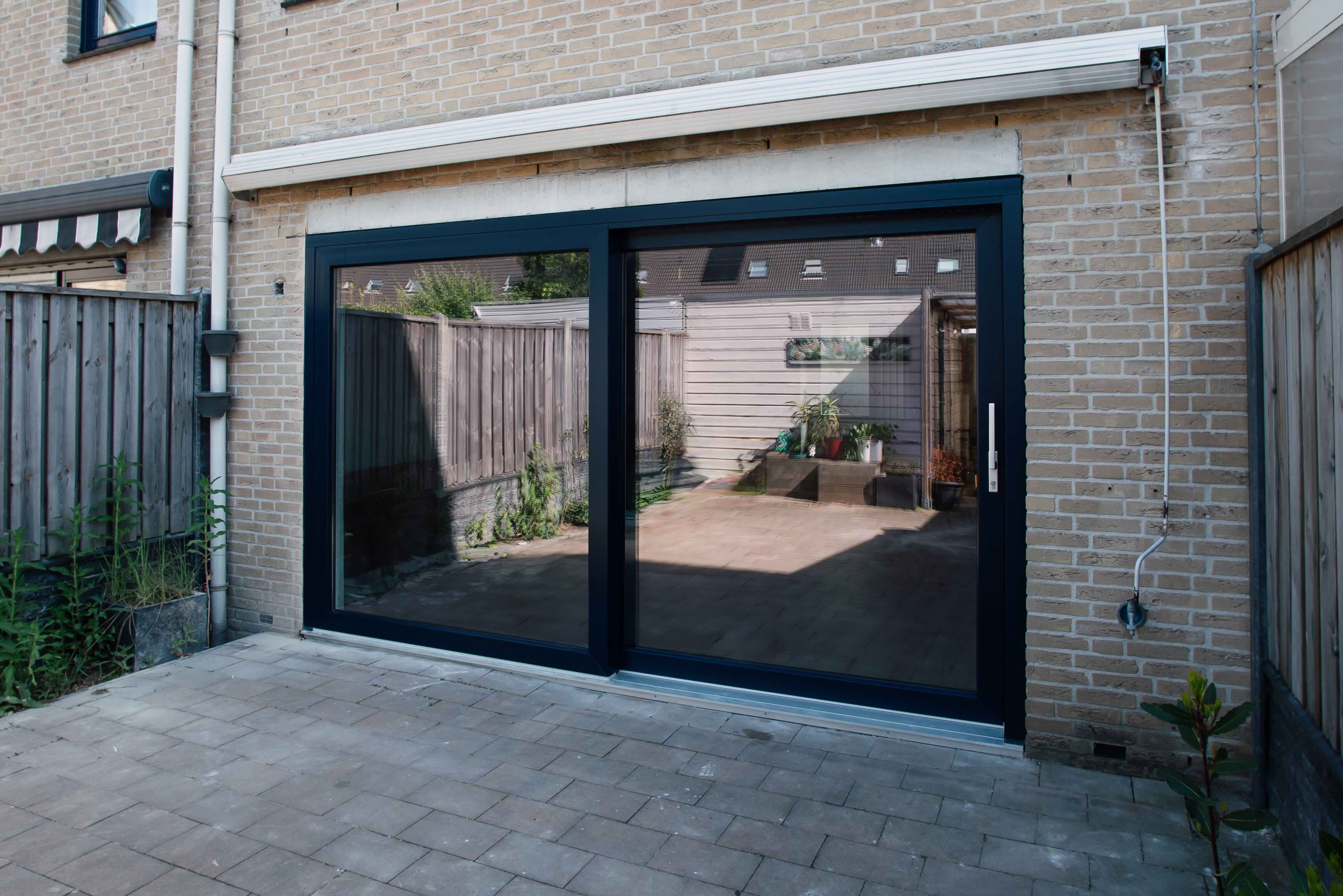 An anthracite sliding patio door in a rear elevation, installed by Soleca